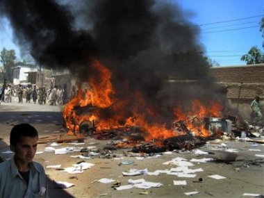 (11-May-05) A car burns in the street as university students protest in the steets in Jalalabad, Afghanistan <font size=-2>(Source: AP)</font>