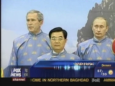 George Bush, Russian President Vladimir Putin and Chinese President Hu Jintao enjoy a moment of cheer together at APEC, dressed in traditional "ao dai" robes