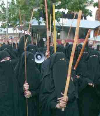 Protesting female students at Red Mosque seminary wearing burkas and carrying bamboo sticks