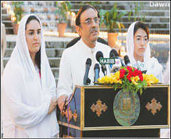 President-elect Asif ali Zardari, flanked by daughters Bakhtawar and Asifa, speaks to his party colleagues and supporters at the Prime Minister's House on Saturday evening. <font face=Arial size=-2>(Source: dawn.com)</font>