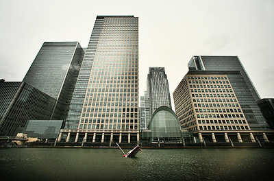 The sinking boat is actually a sculpture, in the Thames river in front of London's business center. <font size=-2>(Source: time.com)</font>