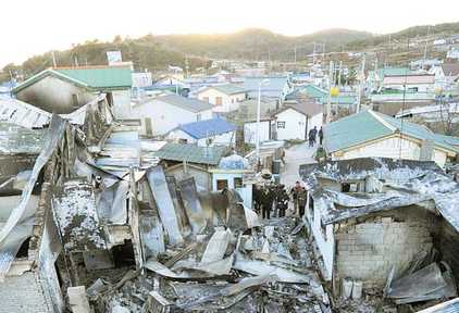 Destroyed houses on the once calm Yeonpyeong Island (Independent)