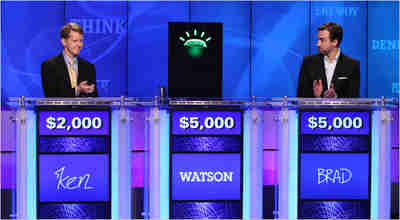 Ken Jennings, Watson's avatar, and Brad Rutter prepare to play Jeopardy!