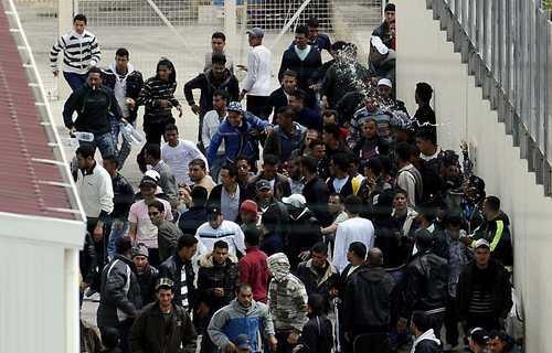 Migrants protesting in a temporary shelter on Lampedusa Island (AFP)