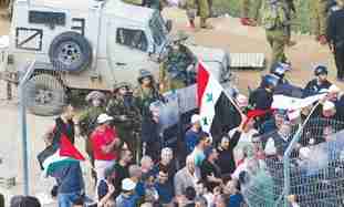 Protesters breaking through border fence on May 15 (Reuters)