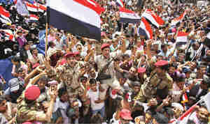 Yemeni army soldiers lifted by anti-government protesters, celebrate Saleh's departure (AP)