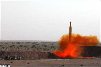 Iranian revolutionary Guards personnel watch a missile launch on Tuesday. (Payvand)