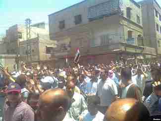 Demonstrators march through the streets of Damascus on July 1 (RFE/RL)