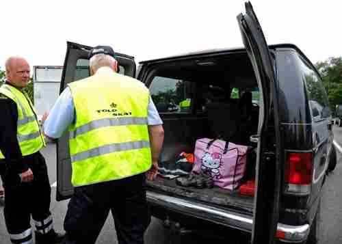 Danish customers officer inspects a vehicle on Tuesday on border with Germany.  (Reuters)