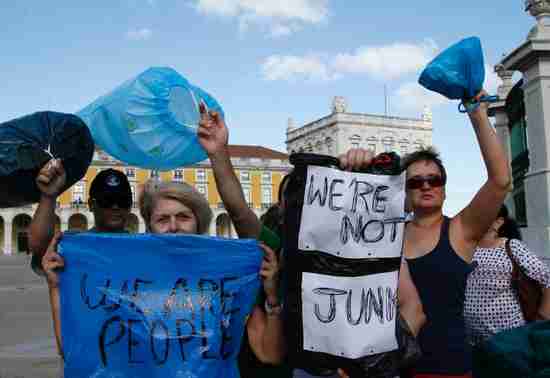 In Lisbon, protesters demonstrate against Moody's downgrading Portugal's government bonds to junk (Reuters)