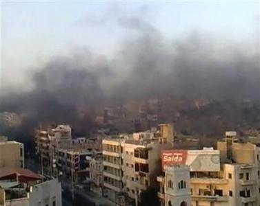 Smoke rises in the city of Hama on July 31, 2011 (Reuters)