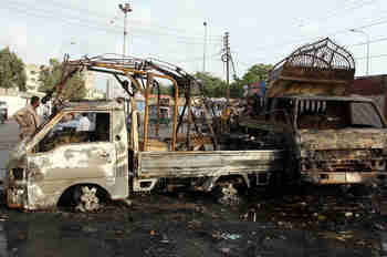 Burned out vehicles in Karachi (EPA)