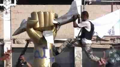 Rebel fighter tears down the iconic giant golden hand crushing a US fighter jet (BBC)