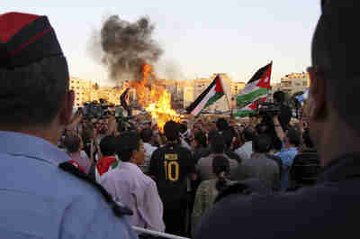 Protesters shout anti-US and Israeli slogans outside the US embassy in Amman (Reuters)