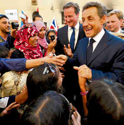 Cameron and Sarkozy meet cheering crowds in Benghazi on Thursday (Reuters)