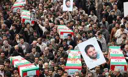 Iranians carry honorary coffins and pictures of Hassan Tehrani Moghaddam in a funeral procession (Reuters)