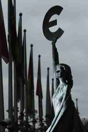 Statue of girl holding the Euro symbol in front of the European Parliament building (Getty)