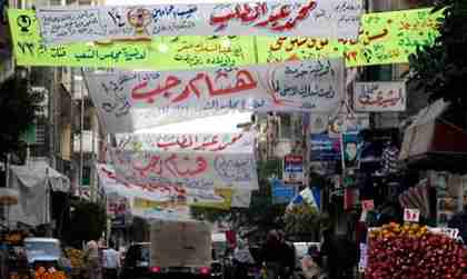 Cairo street with competing political signs (Reuters)