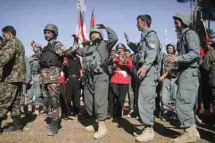 Afghan security forces dance as authority is transferred to them from Nato forces (AP)