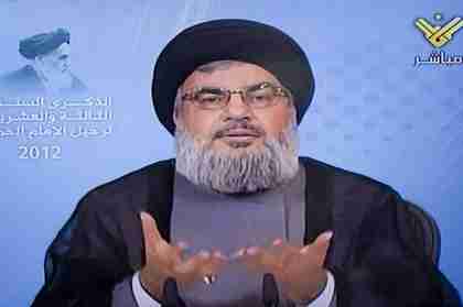  Sayyed Hasan Nasrallah on television Friday.  Iran's Supreme Leader is in the upper left corner. (The Daily Star, Lebanon)