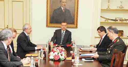 Beneath a portrait of Ataturk, Recep Tayyip Erdogan leads a cabinet meeting to discuss the response to Syria's downing a Turkish jet (AA)