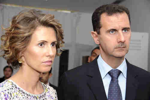 Bashar al-Assad, who wears a Hitler-like mustache, and his lovely wife Asma.  Supposedly, the e-mail messages contain personal information about their relationship. (AP)