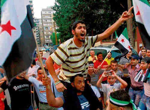 Sunnis in northern Lebanon celebrating the bombing of Damascus.  That poor guy on the bottom looks like he's about to throw up.  (Reuters)