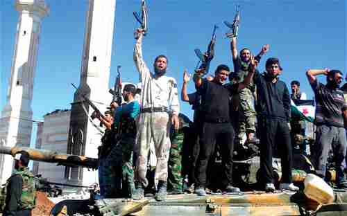 Syrian rebels stand on a tank in Aleppo (EPA)