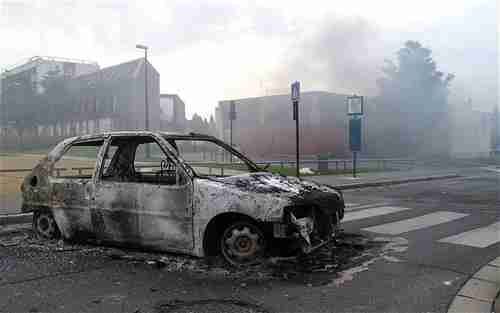 Burnt out car in Amiens (AP)