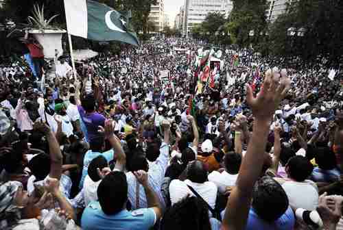 Thousands of mostly Pakistani immigrants protest in Athens on Friday (AFP)