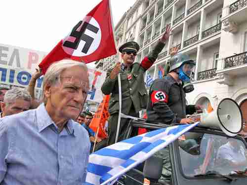 Angela Merkel greeted with Nazi salutes and violence in Athens (Getty)