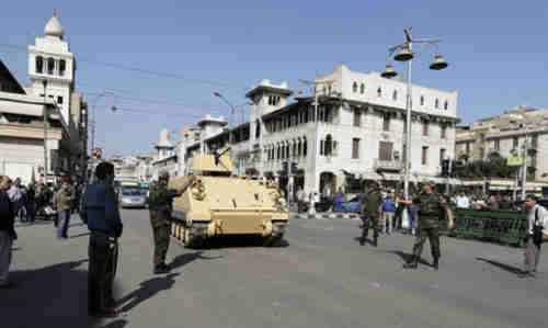 A tank rolls down the street in Cairo (Reuters)