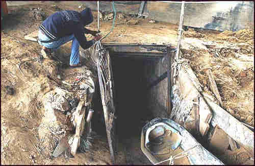 An Arab working outside a smuggling tunnel connecting Gaza with Egypt