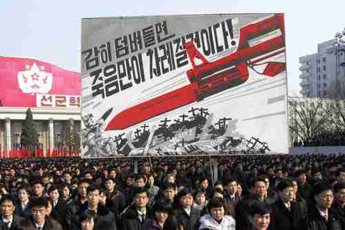 N. Korean rally in Pyongyang in front of billboard that depicts a large bayonet pointing at U.S. soldiers and reads, 'If you dare invade, only death will be waiting for you!' (AP)