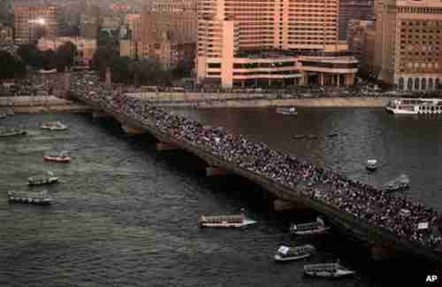 Anti-Morsi demonstrators cross a bridge in Cairo on Friday (BBC)