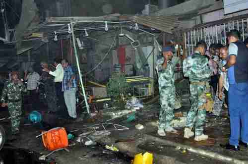 Remains of Baghdad cafe after being struck by one of a dozen car bombs on Saturday (AFP)