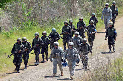 Philippine (left) and U.S. (right) troops conduct joint live fire exercises in Philippines in April (AFP)