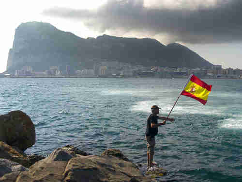 A fisherman holds a Spanish flag during a protest in the bay of Algeciras, near the Rock of Gibraltar, on Sunday (AP)