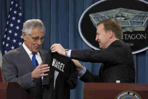 Defense Secretary Chuck Hagel receives a rugby jersey from New Zealand Defense Minister Jonathan Coleman on Monday