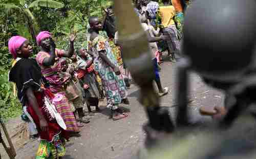 Residents cheer as Congolese soldiers pass through after defeating M23 rebels (AP)