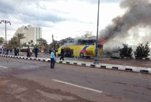 Smoke rises from tourist bus on Sunday (Reuters)