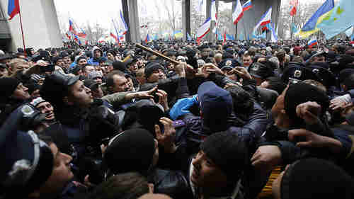 Pro-Russian protesters (left) clash with Crimean Tatars (right) on Wednesday (AP)