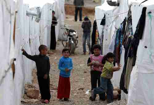 Syrian children play at a refugee camp in Arsal on Friday.  A suicide car bomb exploded on Saturday.  (AFP)