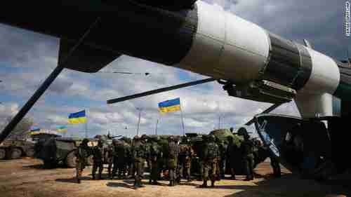 Ukrainian troops receive munitions at a field in east Ukraine on Tuesday (CNN)