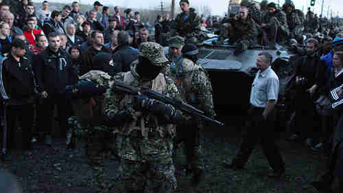 Pro-Russian activists block Ukrainian soldiers in armored personnel carriers in east Ukraine on Wednesday (AFP)