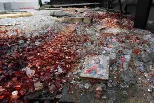 A blood-stained icon of Jesus lies in blood-soaked shattered glass after a clash on Tuesday at Donetsk airport (Reuters)