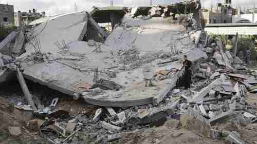 Palestinians inspect the site of an Israeli air strike on Gaza (BBC)