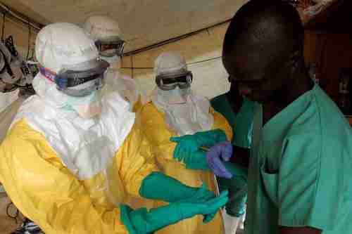 Health workers wearing suits to protect themselves from Ebola (EPA)