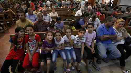 Iraqi Christians who fled the city of Qaraqosh and are now sitting in Saint Joseph Church in Erbil (BBC)