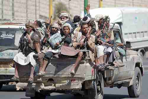 Houthi fighters in back of pickup truck on Sunday in Sanaa (AFP)